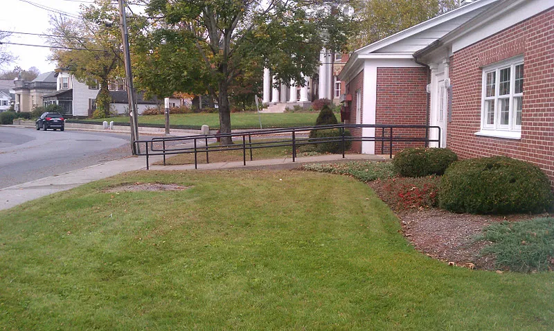 Mowed lawn and trimmed shrubs at a commercial property in Massachusetts
