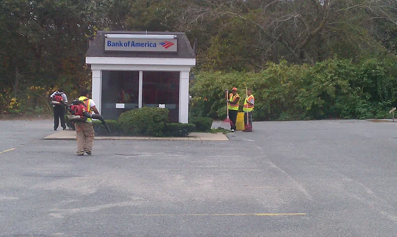 Crew blowing and sweeping debris during a commercial property cleanup in Massachusetts