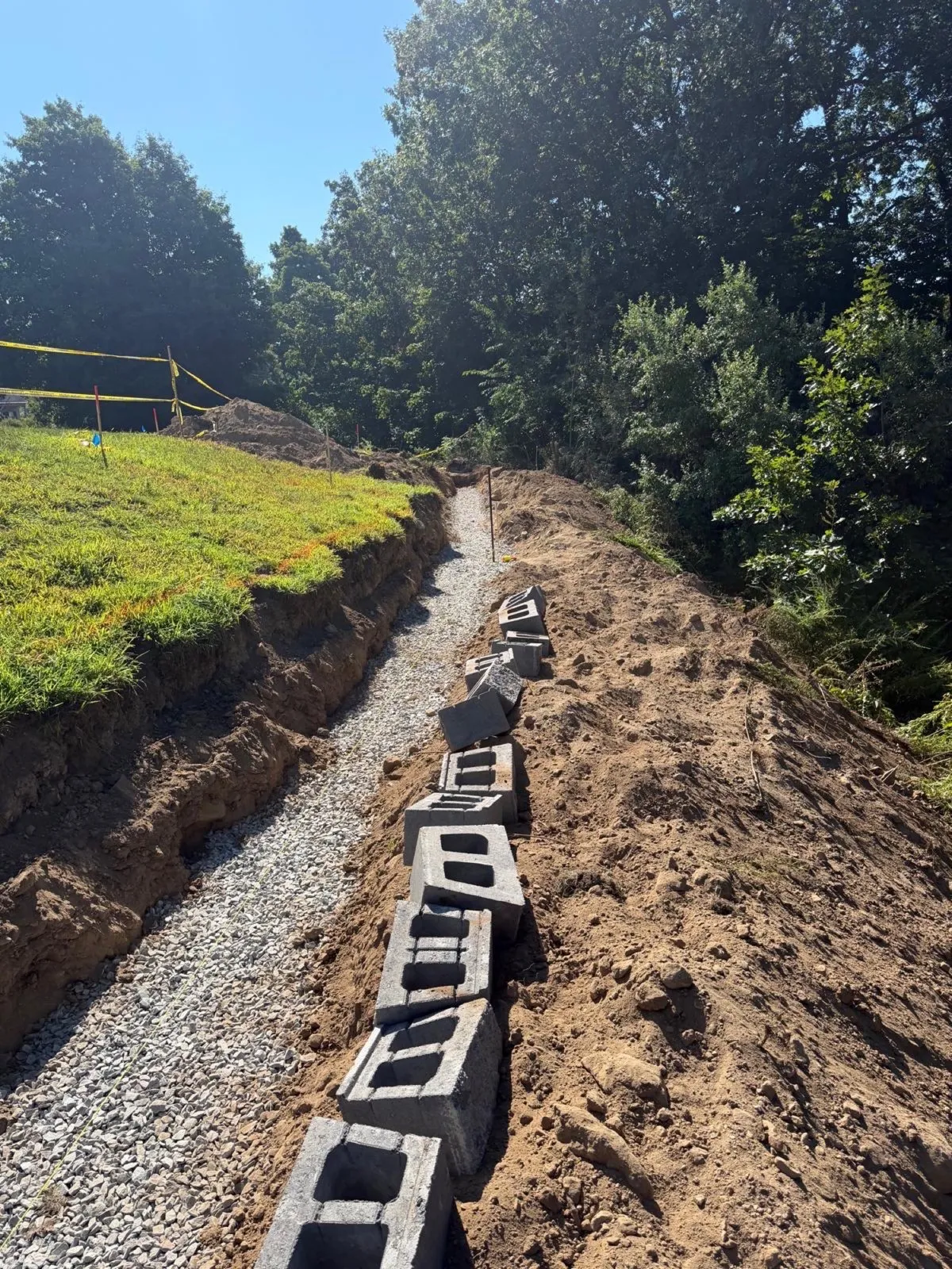 Retaining wall installation with a drainage trench in Massachusetts